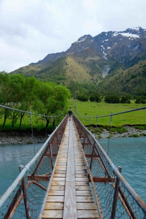 Swing bridge over the glacial blue of the Matukituki River Matukituki valley bridge